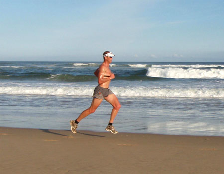 Conrad Stoltz running on the beach