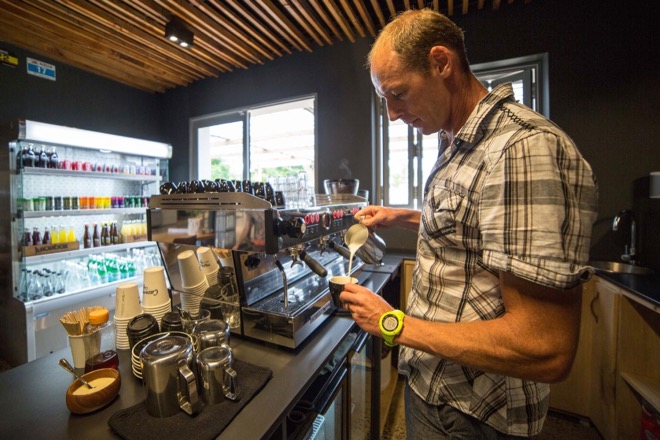 Caveman Conrad Stoltz pouring flat whites atCaveman Cafe